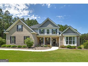 Beautiful two-story home with a well-manicured lawn and charming brick and siding exterior at 433 Wilson Dr, Mcdonough, GA 30252
