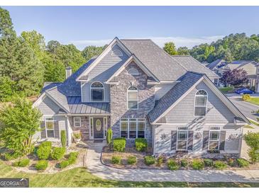 Beautiful two-story home featuring manicured landscaping, stone accents, and a classic architectural design at 100 Harmony Ct, Dallas, GA 30157
