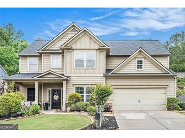 Charming two-story home with a well-manicured lawn, beautiful landscaping and a two car garage at 230 Haleys Ct, Woodstock, GA 30188