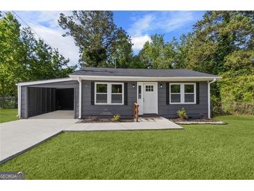 Charming single-story home boasts a well-maintained lawn, attached carport, and inviting front entrance at 389 Oglesby Bridge, Conyers, GA 30094