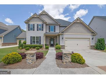 Charming two-story home with well-manicured lawn and inviting front entrance at 675 Mallard Cv, Loganville, GA 30052