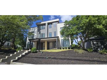 Striking contemporary home with a manicured lawn, lush landscaping, and an inviting front porch at 81 Walthall Se St, Atlanta, GA 30316