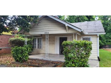 Street view of a quaint single-story home with covered porch and trimmed bushes at 2916 Memorial Se Dr, Atlanta, GA 30317