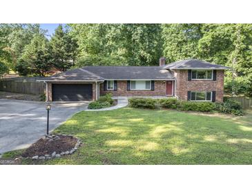 Charming single Gathering home with manicured front lawn and brick facade, nestled in a lush, green neighborhood at 23 Hunting Creek Dr, Marietta, GA 30068