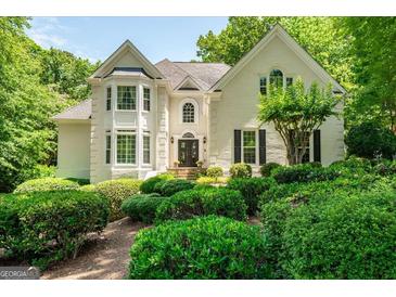 Charming two-story brick home with well-manicured landscaping and a symmetrical facade at 162 Daltree Ct, Marietta, GA 30068