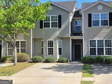 Charming townhome featuring a well-manicured lawn and inviting curb appeal, perfect for comfortable living at 2268 Nicole Dr, Hampton, GA 30228