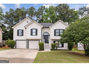 Charming two-story home with a well-manicured lawn and attached two-car garage at 4733 Julian Way, Acworth, GA 30101