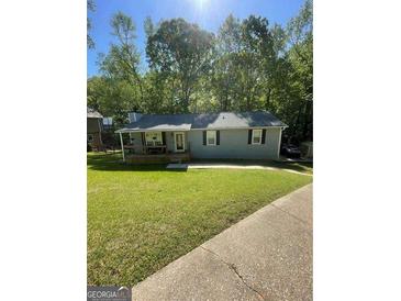 Charming single-story home with gray siding, front porch, and well-maintained lawn at 4070 Feather Dr, Douglasville, GA 30135