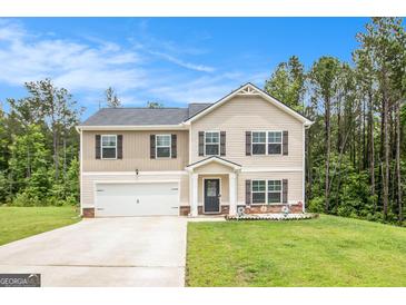 Charming two-story home featuring a two-car garage and well-maintained front lawn at 210 Jenny Ct, Grantville, GA 30220