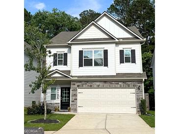 Charming two-story home with white siding, black shutters, and a stone-accented garage at 158 Bryon Ln, Acworth, GA 30102