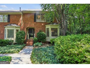 Charming brick townhouse with manicured landscaping and bay windows at 1386 Sheffield Glen Ne Way, Atlanta, GA 30329