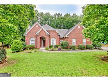 Beautiful brick home with well-manicured lawn and mature trees at 835 Virginia Parks, Fayetteville, GA 30215
