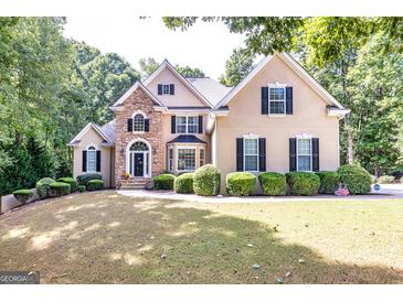 Stunning two-story home with stone accents, mature landscaping, and classic design at 235 Ashley Forest Dr, Fayetteville, GA 30214