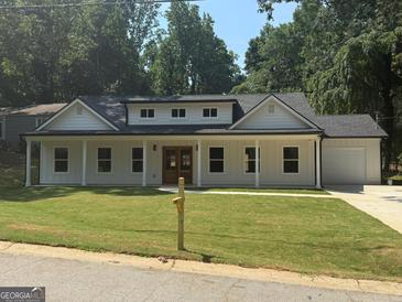 Charming single-Gathering home featuring a covered porch and well-manicured lawn at 5431 S Lake Dr, Douglasville, GA 30135
