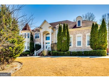 Stately brick home featuring manicured landscaping and a circular driveway for added curb appeal at 1214 Greenridge Ln, Lithonia, GA 30058
