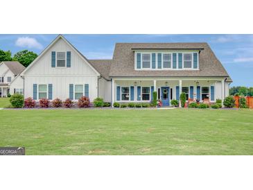 Charming two-story home featuring a welcoming front porch and lush green lawn at 17 Sawtooth Oak Dr, Moreland, GA 30259