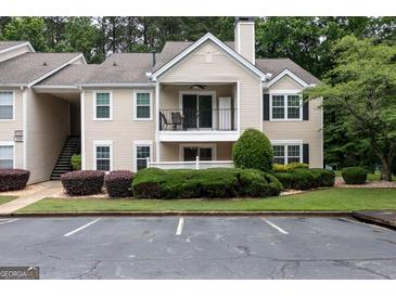 Charming condo with balcony, manicured landscaping, and designated parking spaces at 1017 Ridgefield Dr, Peachtree City, GA 30269