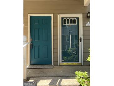A charming blue front door, providing a warm and inviting entrance to the home at 6420 Pinebark Way, Morrow, GA 30260