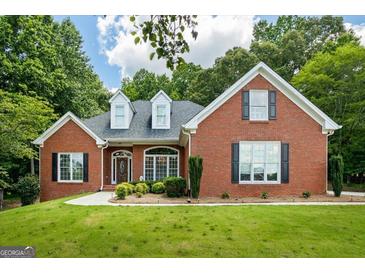 Charming red brick home with black shutters, dormers, and manicured lawn at 40 Costleys Bridge Dr, Oxford, GA 30054