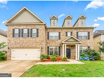 Charming two-story home with a brick facade, manicured lawn, and a two-car garage at 412 Culloden Moor, Mcdongough, GA 30253