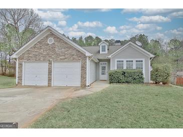 Charming single-Gathering home with stone accents, vinyl siding, attached garage, and well-maintained landscaping at 131 Meadowbrook Ln, Grantville, GA 30220