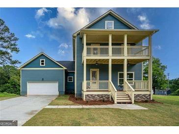 New construction features a double porch, well-manicured lawn and an attached garage at 1993 Reynolds Sw Dr, Atlanta, GA 30315