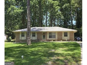 Charming brick home with a well-manicured lawn and mature trees at 10178 Top Tree Ct, Jonesboro, GA 30238