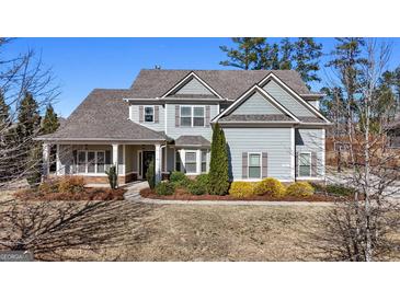 Charming two-story home with well-maintained landscaping, light-blue paint, and welcoming curb appeal at 240 Sturry Dr, Mcdonough, GA 30252