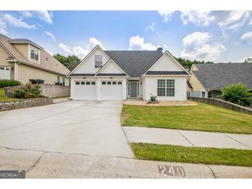 Charming home with a well-manicured lawn, three-car garage, and inviting curb appeal at 240 Turnbridge Cir, Peachtree City, GA 30269