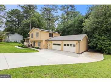 Inviting two-story home with a spacious driveway and attached two car garage at 423 Mephisto Cir, Lawrenceville, GA 30046