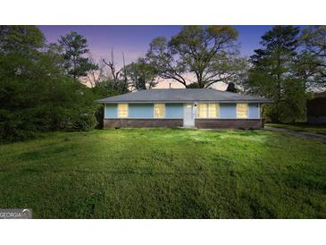 Charming single-story home with a well-maintained lawn and inviting curb appeal at twilight at 758 King Rd, Jonesboro, GA 30236