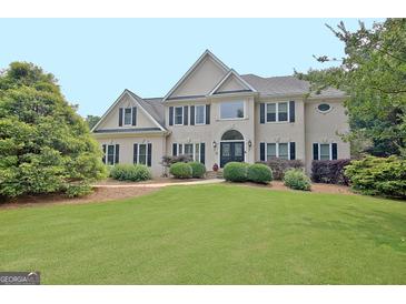 Well-maintained two story home with beautiful yard, landscaping, and traditional design at 104 Hidden Springs Ln, Peachtree City, GA 30269