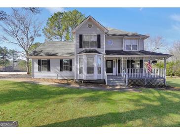 Charming two-story home with a landscaped front yard and inviting front porch at 701 Monticello Ln, Mcdonough, GA 30253