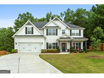 Charming two-story home with a well-manicured lawn, two car garage and tasteful landscaping at 8 Saint Charles Ave, Sharpsburg, GA 30277