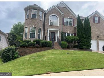 Charming two-story brick home with manicured landscaping and a welcoming front entrance at 3717 Shady Maple Dr, Stonecrest, GA 30038