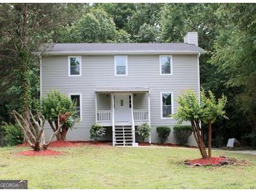Charming two-story home with a well-maintained lawn and inviting front porch at 3858 Trenton Dr, Snellville, GA 30039