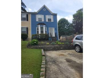 Charming two-story home with blue siding and a well-manicured front yard, featuring a lovely bay window at 2540 Picardy N Cir # B, South Fulton, GA 30349