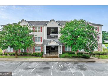 Attractive multi-story condo complex featuring well-maintained landscaping and covered entry at 12303 Waldrop Pl, Decatur, GA 30034