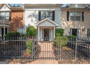 Charming multi-Gathering home featuring a gated front entrance and landscaped yard at 482 N Jeff Davis Dr, Fayetteville, GA 30214