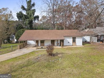 Charming ranch-style home featuring covered carport and a quaint front porch swing at 108 Adrian Dr, Stockbridge, GA 30281