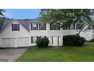 Two-story home featuring a two-car garage, dark shutters, and a symmetrical front design at 3679 Seabass Rd, Decatur, GA 30034
