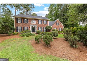 Charming two-story brick home with manicured landscaping and a well-maintained lawn at 108 Summit Walk, Peachtree City, GA 30269