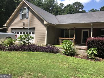 Charming home with a well-maintained lawn, garage, and welcoming front porch at 1744 Campbell Rd, Covington, GA 30014