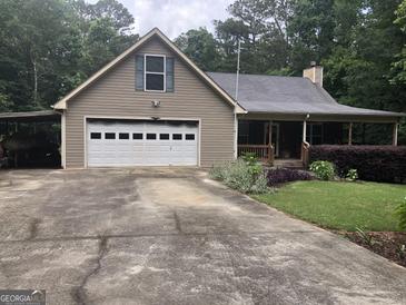 Charming single-story home featuring a two-car garage, covered porch, and a well-maintained landscaped yard at 1744 Campbell Rd, Covington, GA 30014