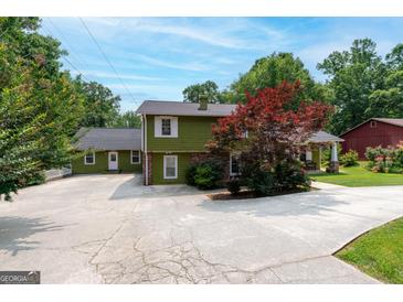 Charming two-story home featuring well-maintained landscaping, a spacious driveway, and a classic covered front porch at 3778 Berdon Ln, Decatur, GA 30034