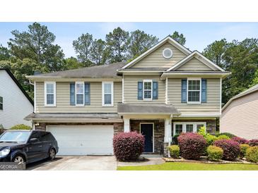 Charming two-story home with a stone-accented facade, attached garage, and well-maintained landscaping at 1875 Cutleaf Creek Rd, Grayson, GA 30017