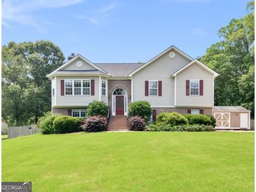 Charming two-story home with well-manicured lawn and cozy red shutters at 230 Cobblestone Ln, Mcdonough, GA 30252