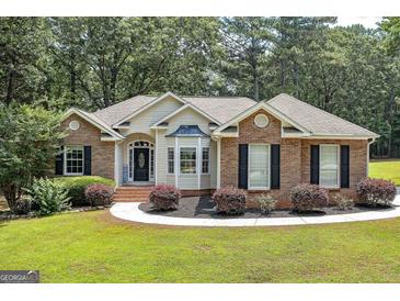 Charming brick and siding home with manicured landscaping and a welcoming entrance at 100 Riveredge Dr, Mcdonough, GA 30252