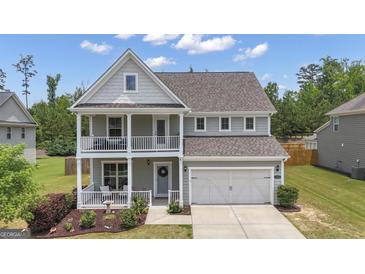 Charming two-story home with double porch, landscaped yard, and two car garage at 206 Roundwood Way, Peachtree City, GA 30269