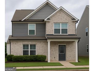 Charming two-story home with a combination of brick and siding, complemented by a well-maintained lawn at 1317 Rosemary Ln # 65, East Point, GA 30344